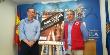 Antonio Miranda y Enrique Roldán junto al cartel anunciador.