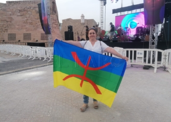 En la imagen una melillense que asiste al Iwa Fest porta la bandera amazigh