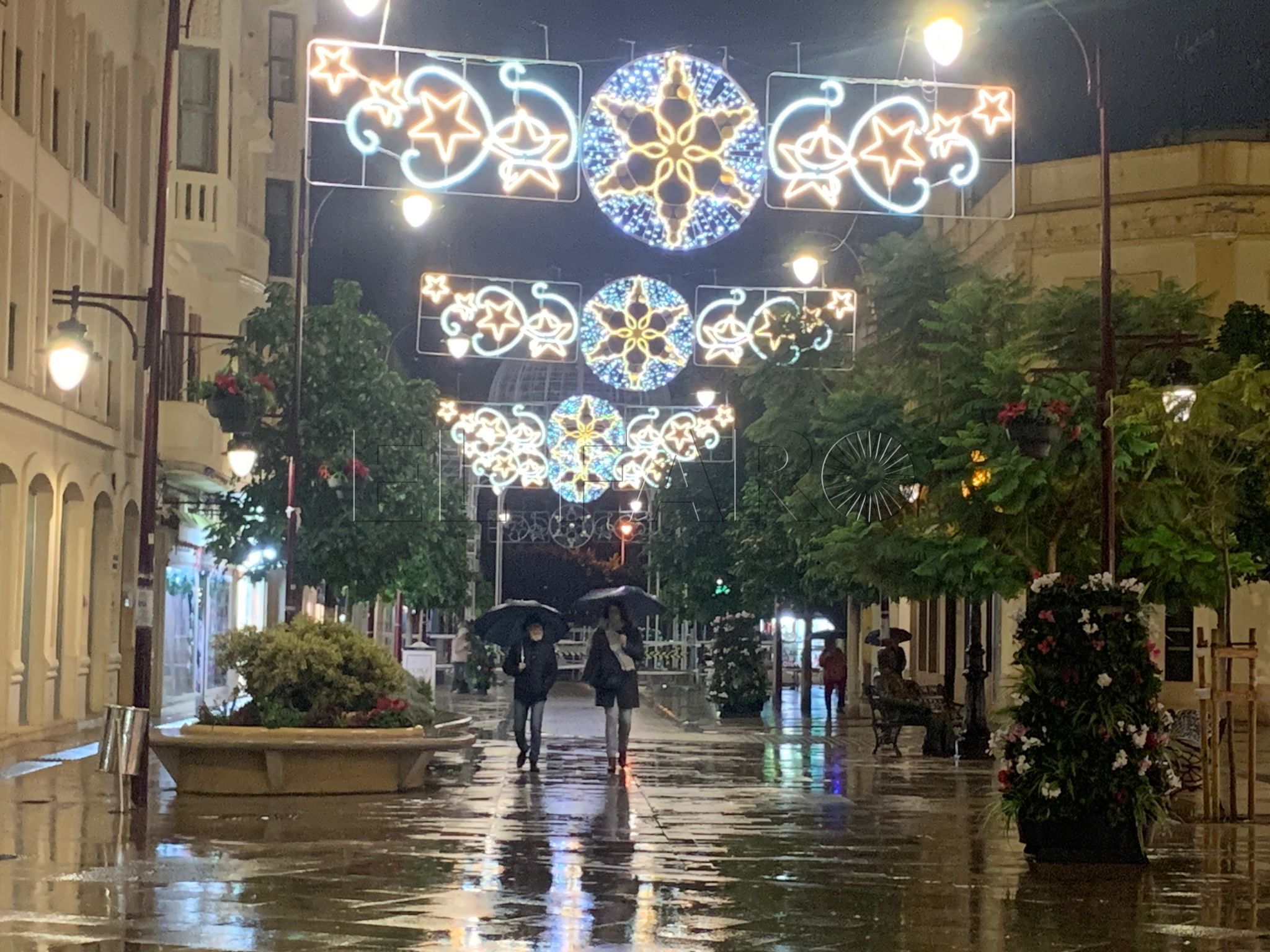 El alumbrado de Navidad se enciende en una tarde de agua