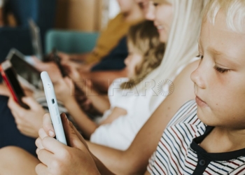 Phone addicted family using their phones on the couch