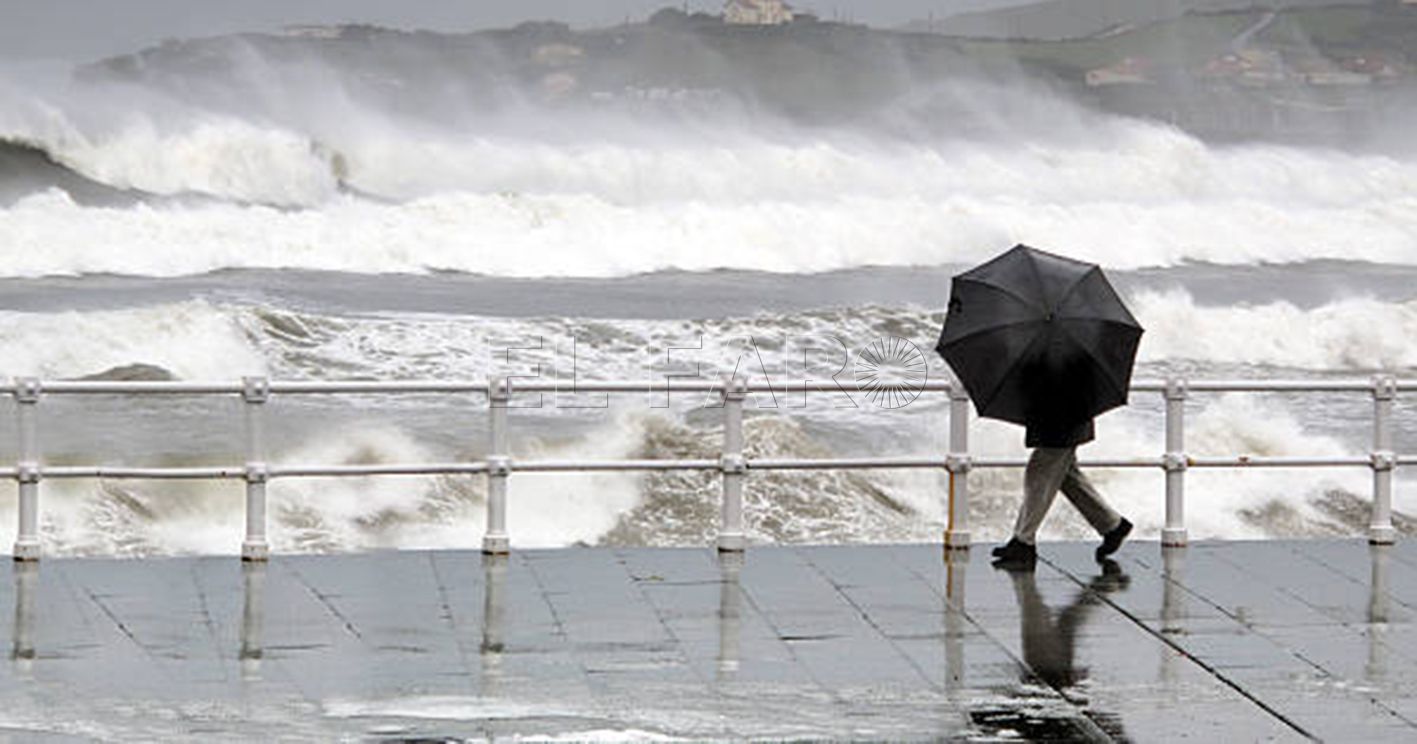 person protecting with umbrella in rainy and windy day walking on promenade with rough sea
