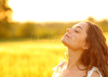 Woman breathing fresh air in a rural environment