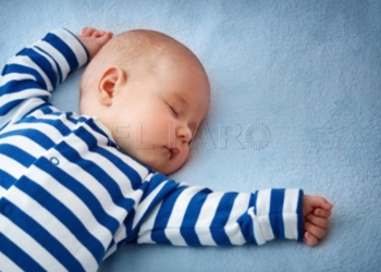 little boy sleeping on soft blue blanket